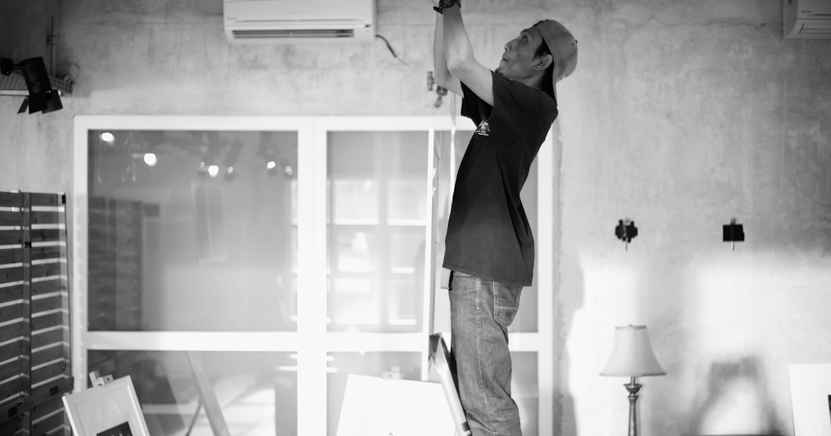 HVAC technician installing air conditioning unit