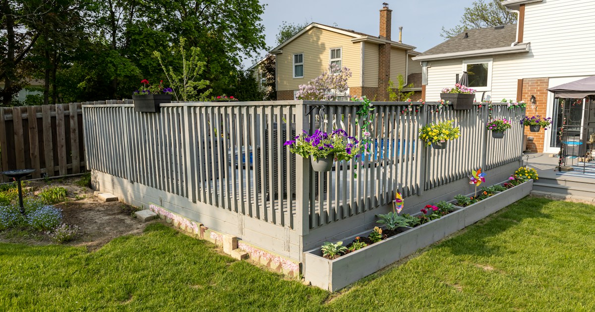 Backyard with modern deck and premium privacy fence installation